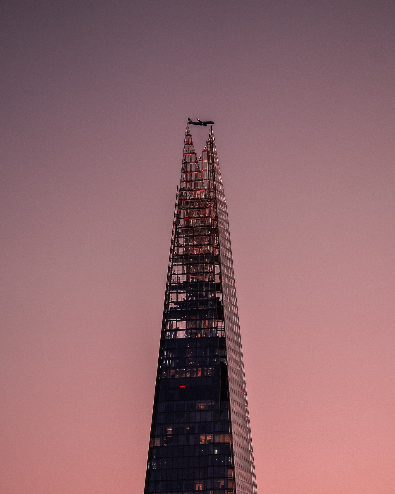A plane crossing above The Shard in London.